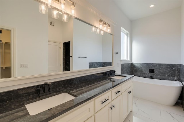 bathroom featuring a bathing tub and vanity