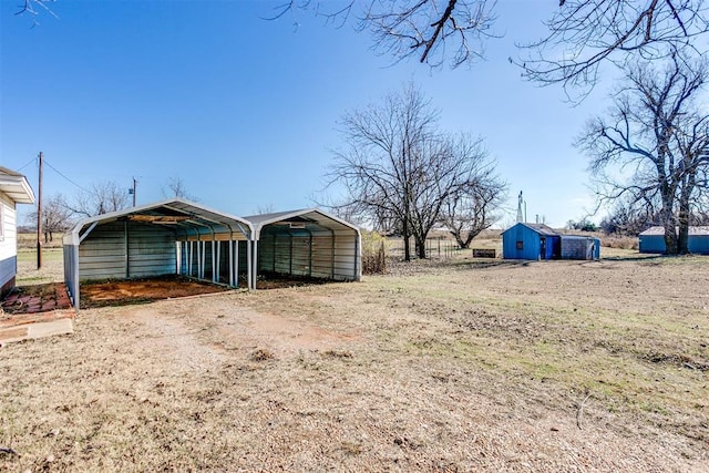 view of yard featuring a carport and a storage shed