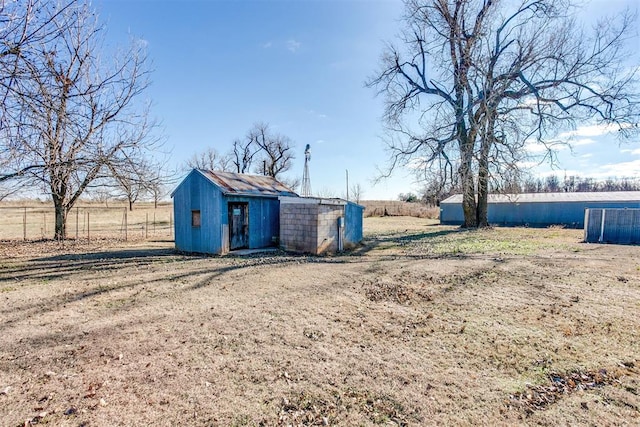 view of yard with a rural view and a shed