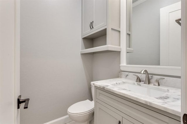 bathroom with vanity, toilet, and crown molding