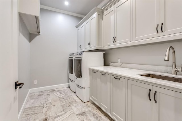 laundry area with washer and clothes dryer, crown molding, cabinets, and sink