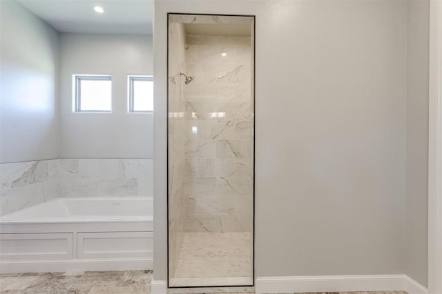 bathroom featuring separate shower and tub