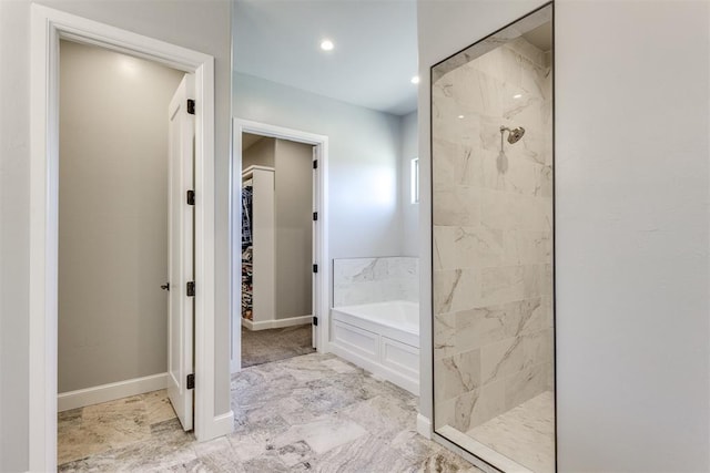 bathroom featuring independent shower and bath