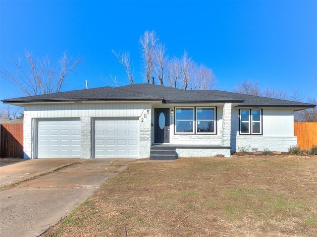 single story home with a front yard and a garage