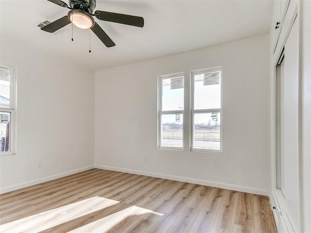 spare room featuring light hardwood / wood-style floors and ceiling fan