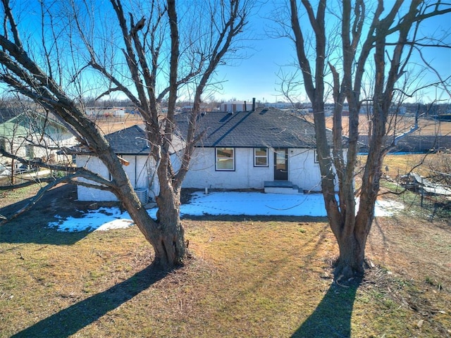 rear view of property featuring a lawn and a patio