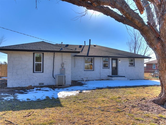 rear view of house with a patio, central AC, and a lawn