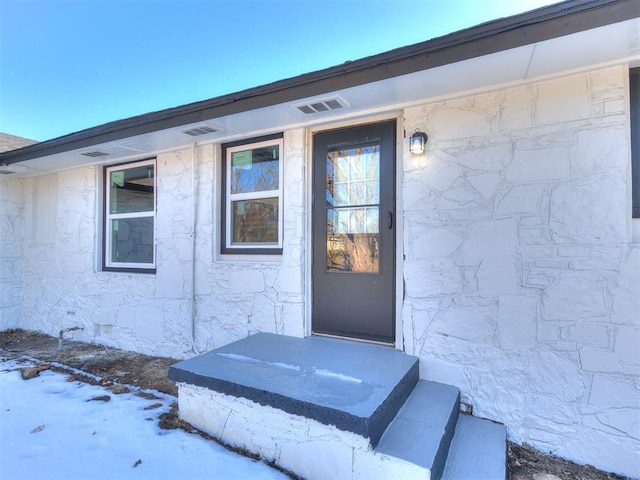 view of snow covered property entrance