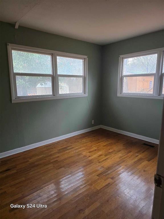 unfurnished room featuring dark hardwood / wood-style flooring