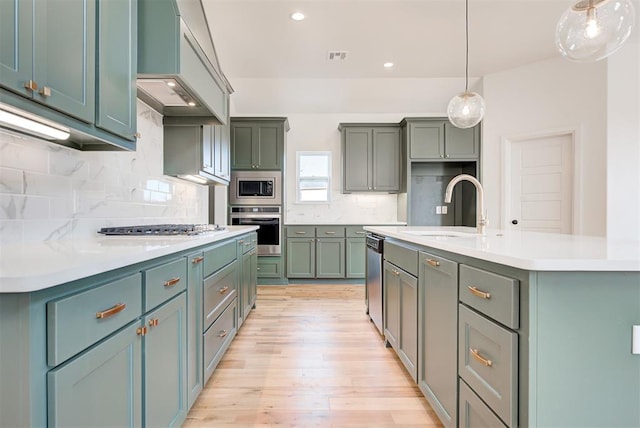 kitchen featuring stainless steel appliances, a sink, light countertops, custom exhaust hood, and backsplash