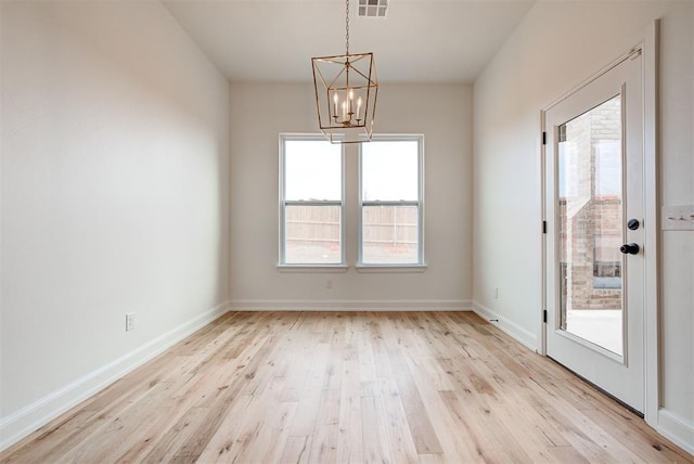 unfurnished dining area featuring a chandelier, light wood-type flooring, visible vents, and baseboards