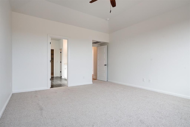 unfurnished bedroom with visible vents, dark carpet, baseboards, and ceiling fan