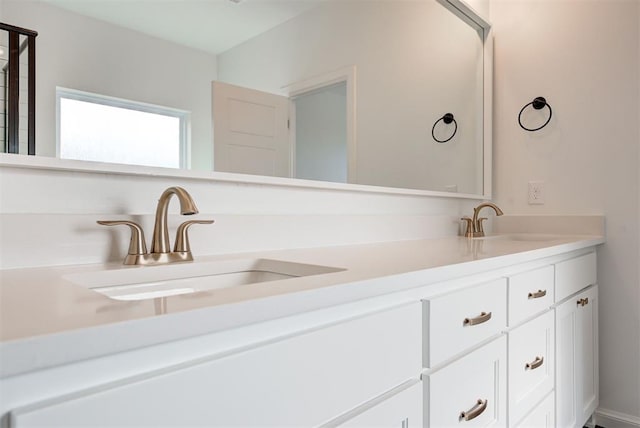 full bathroom featuring double vanity and a sink