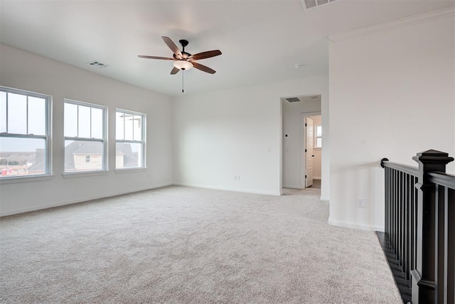 unfurnished room featuring ceiling fan, visible vents, baseboards, and carpet flooring