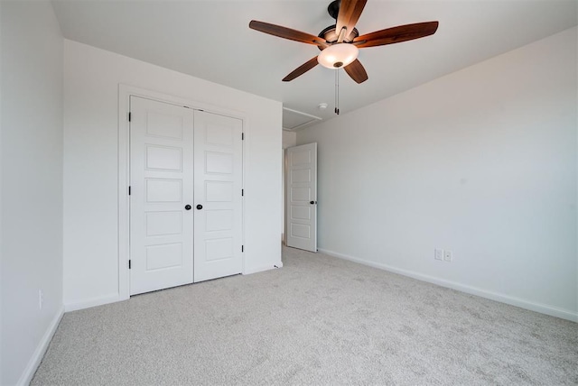 unfurnished bedroom featuring light carpet, a ceiling fan, baseboards, and a closet