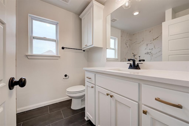 full bathroom featuring decorative backsplash, toilet, vanity, baseboards, and walk in shower