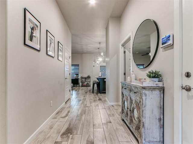 hallway with a chandelier