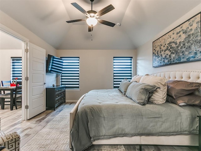 bedroom featuring ceiling fan, vaulted ceiling, and light wood-type flooring