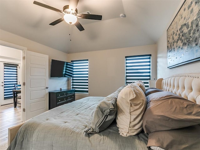 bedroom with light wood-type flooring, ceiling fan, and lofted ceiling