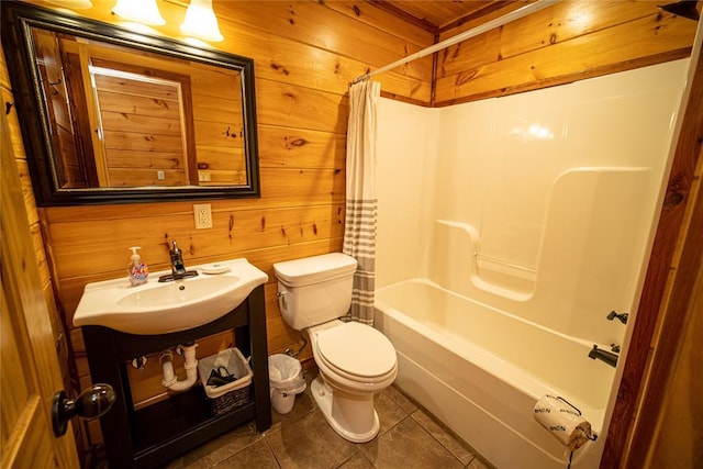 full bathroom featuring tile patterned flooring, sink, and wooden walls