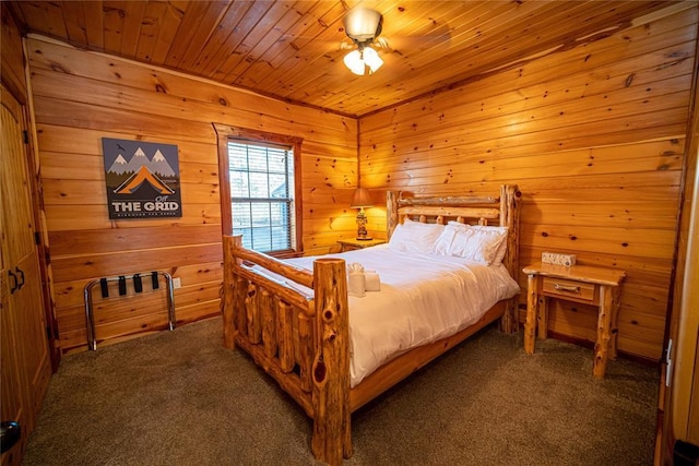 bedroom with dark colored carpet, ceiling fan, and wood ceiling