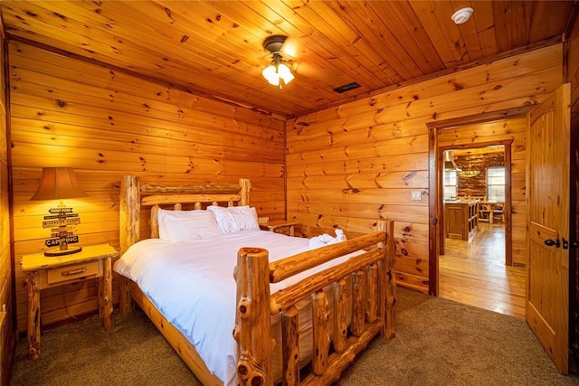 carpeted bedroom with ceiling fan and wood ceiling