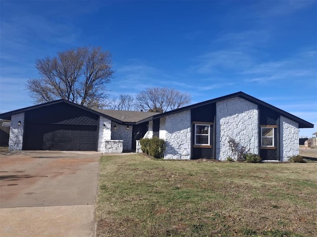 ranch-style home with a garage and a front lawn