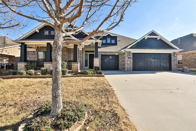 craftsman inspired home featuring covered porch and a garage