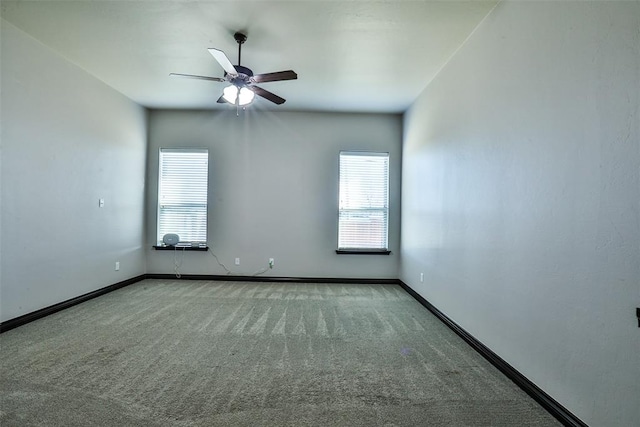 empty room with carpet flooring, a wealth of natural light, and ceiling fan