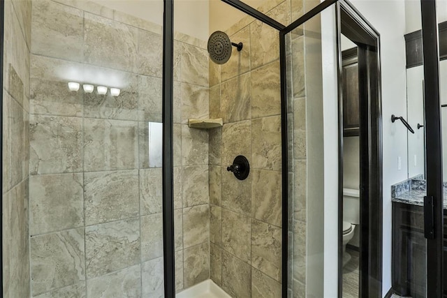 bathroom with tiled shower and toilet