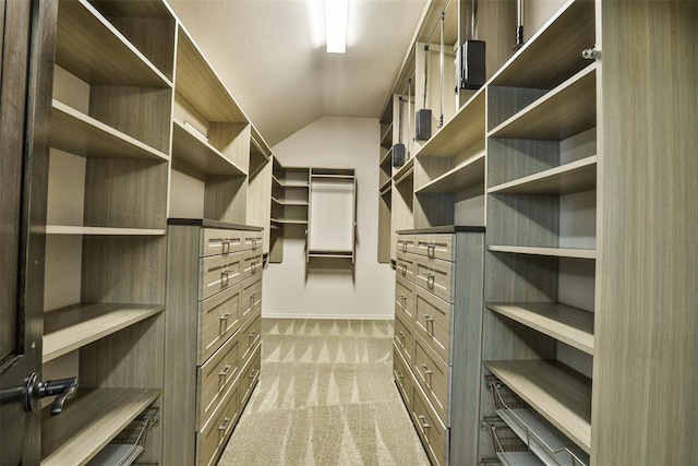 spacious closet featuring carpet floors and lofted ceiling