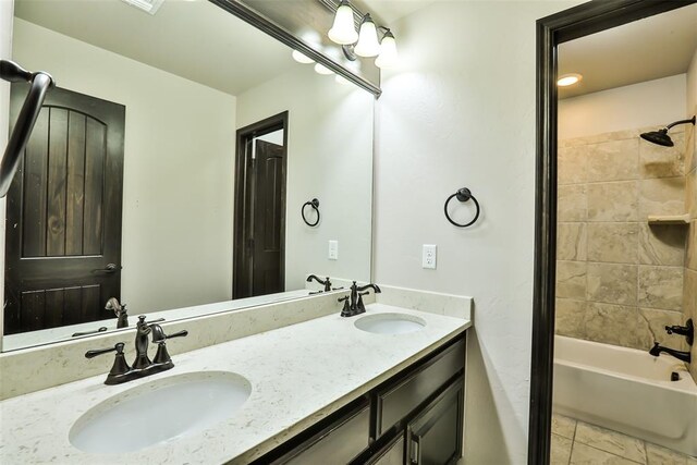 bathroom with vanity, tile patterned floors, and tiled shower / bath combo