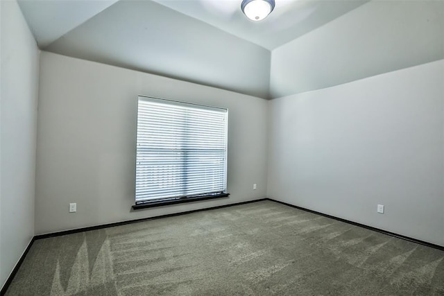 empty room with light carpet and lofted ceiling