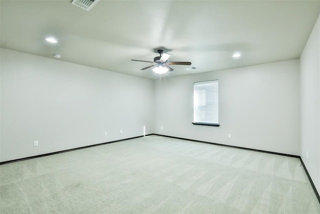 empty room featuring light carpet and ceiling fan