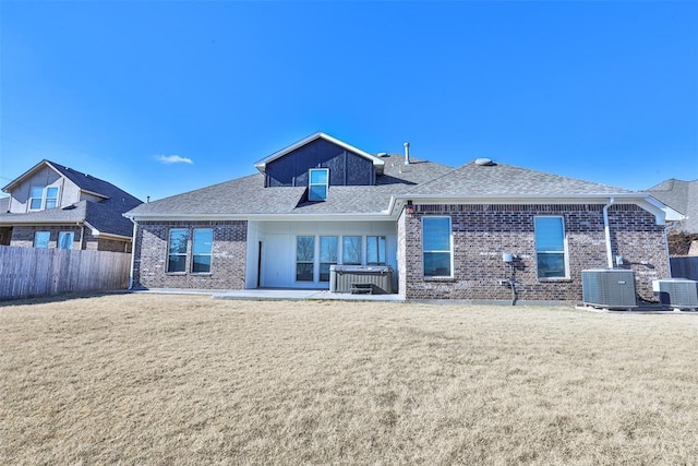 back of house with a patio area, central air condition unit, and a yard