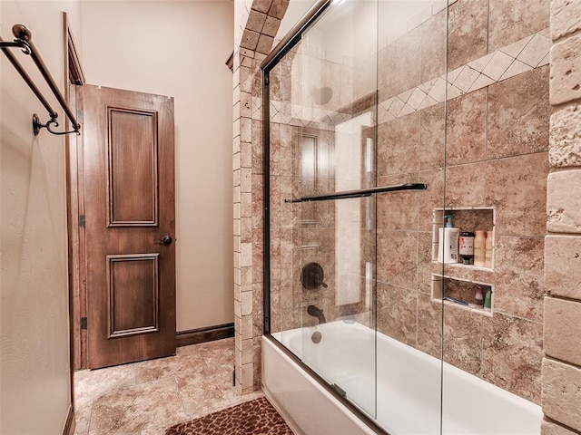 bathroom featuring bath / shower combo with glass door