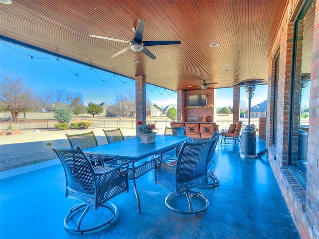 view of patio / terrace featuring an outdoor stone fireplace and ceiling fan