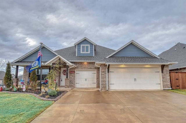 view of front of house with a garage and a front lawn