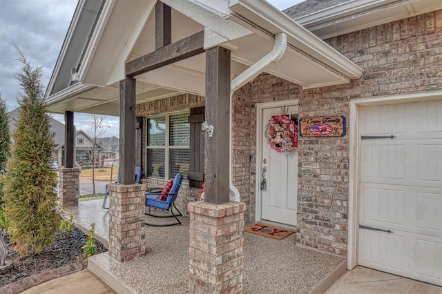 entrance to property featuring a porch and a garage