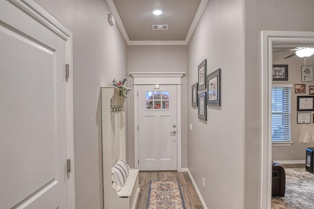 entryway with hardwood / wood-style floors, ceiling fan, crown molding, and a healthy amount of sunlight