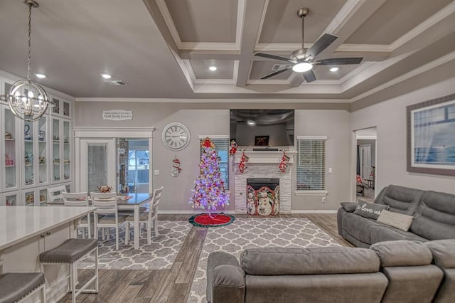 living room featuring a fireplace, wood-type flooring, and ornamental molding