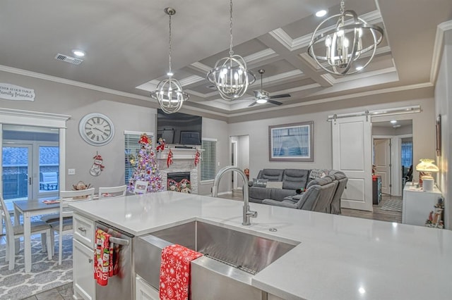 kitchen featuring ornamental molding, coffered ceiling, sink, beam ceiling, and a barn door