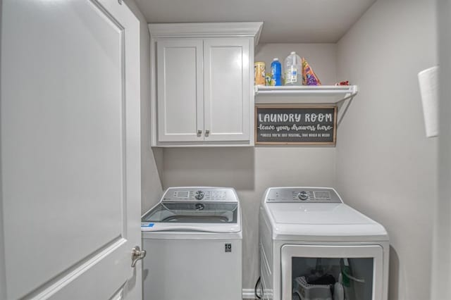 washroom with cabinets and washing machine and dryer