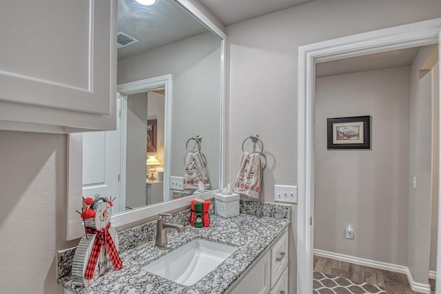 bathroom featuring wood-type flooring and vanity