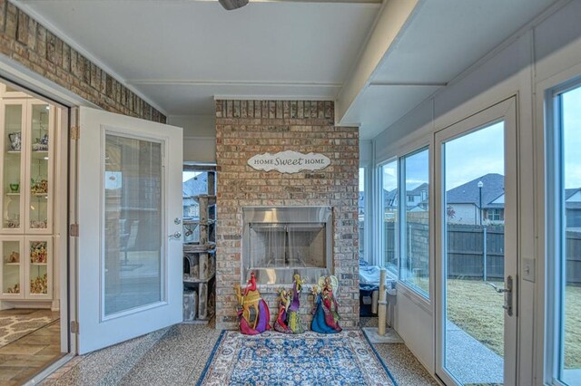 sunroom featuring a fireplace