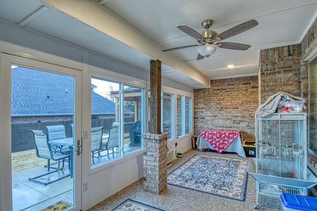 sunroom with ceiling fan