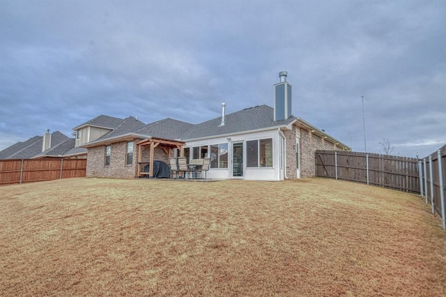 rear view of house with a yard and a patio area