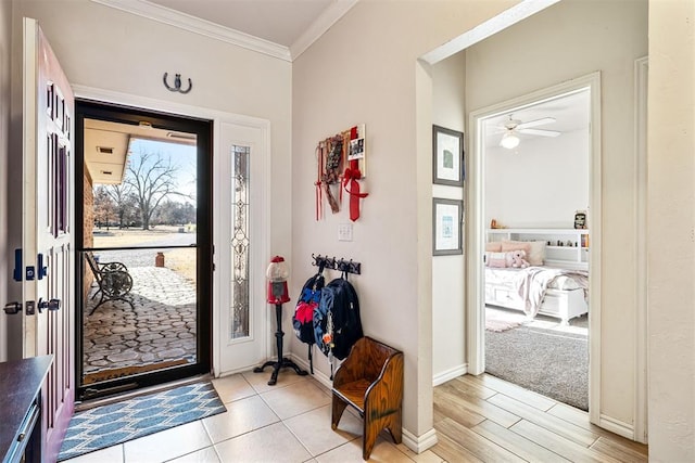 entryway featuring ceiling fan, light hardwood / wood-style flooring, and ornamental molding