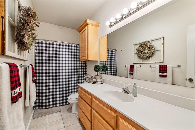 bathroom featuring tile patterned flooring, vanity, and toilet