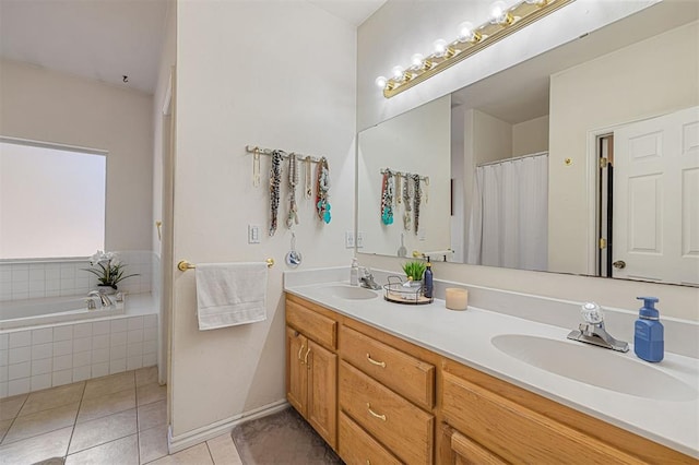 bathroom featuring tile patterned floors, tiled tub, and vanity